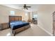 Bright bedroom featuring a ceiling fan, study area with a large wood bed, and neutral-colored walls at 606 Riviera Dunes Way # 604, Palmetto, FL 34221