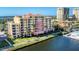 Stunning waterfront condominium with vibrant colors, multiple balconies, and lush landscaping at 606 Riviera Dunes Way # 604, Palmetto, FL 34221