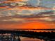 Picturesque sunset view over the marina, casting vibrant orange and yellow hues across the sky and reflecting in the water at 606 Riviera Dunes Way # 604, Palmetto, FL 34221
