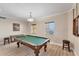 A beautifully appointed game room featuring a pool table, hardwood floors, and plenty of natural light at 606 Riviera Dunes Way # 604, Palmetto, FL 34221