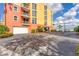 Condominium parking area featuring multiple garage doors and covered parking with waterfront views at 606 Riviera Dunes Way # 604, Palmetto, FL 34221