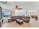 Inviting living room with a large sectional sofa, wood floors, and access to a balcony offering scenic views at 606 Riviera Dunes Way # 604, Palmetto, FL 34221