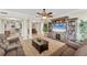 Open-concept living room with decorative columns, neutral tones, and wood flooring for a spacious and airy feel at 606 Riviera Dunes Way # 604, Palmetto, FL 34221
