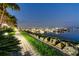 Picturesque walkway beside a calm marina filled with boats and lined with lush landscaping at 606 Riviera Dunes Way # 604, Palmetto, FL 34221