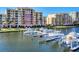 Waterfront condos featuring a private boat dock with multiple boats along the marina at 606 Riviera Dunes Way # 604, Palmetto, FL 34221