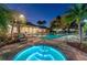 Relaxing pool area with a hot tub, surrounded by palm trees and comfortable lounge chairs at 606 Riviera Dunes Way # 604, Palmetto, FL 34221
