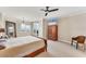 Main bedroom featuring a large bed, ceiling fan, and great water views at 606 Riviera Dunes Way # 604, Palmetto, FL 34221