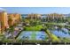 View of the tennis courts with a picturesque pond and fountain between the courts and the property at 606 Riviera Dunes Way # 604, Palmetto, FL 34221