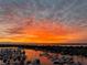 Picturesque sunset view over the marina, casting vibrant orange and yellow hues across the sky and reflecting in the water at 606 Riviera Dunes Way # 604, Palmetto, FL 34221