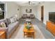 Bright living room featuring a comfortable gray sofa, modern ceiling fan, and stylish decor at 2117 W Paris St, Tampa, FL 33604