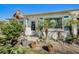 Inviting front entrance with potted plants, a decorative flag, and a well-manicured garden, creating curb appeal at 8711 Beaver Ln # 4, Port Richey, FL 34668