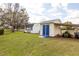 Backyard featuring two sheds, green lawn and mature trees at 3319 Powerline Rd, Lithia, FL 33547