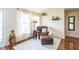 Cozy sitting room with a leather chair, decorative shelves, and plenty of natural light at 3319 Powerline Rd, Lithia, FL 33547