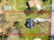 An aerial view shows the entire home sitting on a parcel surrounded by mature trees at 6604 Stafford Terrace Ave, Plant City, FL 33565