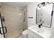 Beautiful bathroom featuring a tiled shower with glass door, modern vanity and sink at 6604 Stafford Terrace Ave, Plant City, FL 33565
