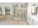 Spacious bathroom featuring a large glass shower, and modern vanity with black fixtures at 6604 Stafford Terrace Ave, Plant City, FL 33565