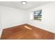 Bedroom featuring hardwood floors, recessed lighting, and a large window at 6604 Stafford Terrace Ave, Plant City, FL 33565