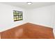 Bedroom featuring hardwood floors, recessed lighting, and a large window at 6604 Stafford Terrace Ave, Plant City, FL 33565