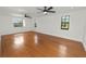 Spacious bedroom featuring hardwood floors, large windows and ceiling fans at 6604 Stafford Terrace Ave, Plant City, FL 33565