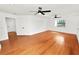 A spacious bedroom with hardwood floors, a ceiling fan and a view to the outside at 6604 Stafford Terrace Ave, Plant City, FL 33565