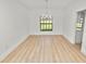 Bright dining room features wood floors, a window with backyard views and a chandelier at 6604 Stafford Terrace Ave, Plant City, FL 33565
