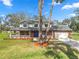 Charming two-story home featuring a brick facade, covered porch, manicured lawn, and attached garage at 6604 Stafford Terrace Ave, Plant City, FL 33565