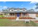 Charming two-story home with brick facade, covered porch and well-manicured flowerbeds at 6604 Stafford Terrace Ave, Plant City, FL 33565