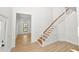 Inviting foyer with elegant wainscoting and a staircase leading to the upper level at 6604 Stafford Terrace Ave, Plant City, FL 33565