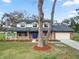 Beautiful brick home featuring a full covered porch and well-manicured lawn at 6604 Stafford Terrace Ave, Plant City, FL 33565