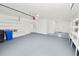Large garage with epoxy flooring, built-in shelving, and multiple access doors at 6604 Stafford Terrace Ave, Plant City, FL 33565