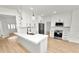 A stylish kitchen features white cabinets, stainless appliances, pendant lighting, and an island with seating at 6604 Stafford Terrace Ave, Plant City, FL 33565