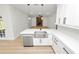 Stylish kitchen with quartz countertops, stainless steel sink, and open layout to living area at 6604 Stafford Terrace Ave, Plant City, FL 33565