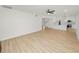 Spacious living room has wood floors and an open-concept layout with the kitchen and staircase at 6604 Stafford Terrace Ave, Plant City, FL 33565