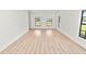A bright and spacious living room with hardwood floors and large windows at 6604 Stafford Terrace Ave, Plant City, FL 33565