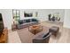 Comfortable living room showcasing stylish furniture, modern decor, and ample natural light from the black framed windows at 6604 Stafford Terrace Ave, Plant City, FL 33565