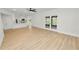 Spacious living room flows into the kitchen, featuring luxury flooring and bright natural light at 6604 Stafford Terrace Ave, Plant City, FL 33565