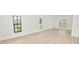 Open living room area with bright vinyl plank floors and multiple windows at 6604 Stafford Terrace Ave, Plant City, FL 33565