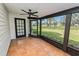 Relaxing screened-in porch with tile flooring, backyard views, and a ceiling fan at 6604 Stafford Terrace Ave, Plant City, FL 33565