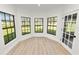 Bright sun room with three black-framed windows providing plentiful natural light and yard views at 6604 Stafford Terrace Ave, Plant City, FL 33565