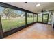 Comfortable screened lanai features tile floor, ceiling fan, and great views of the green backyard at 6604 Stafford Terrace Ave, Plant City, FL 33565