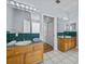 Vintage bathroom featuring tile floors, wood cabinets and dual sinks at 821 Greenview Dr, Apollo Beach, FL 33572