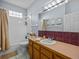 Bathroom features a tub and shower combo, a single sink vanity, and tile floors at 821 Greenview Dr, Apollo Beach, FL 33572