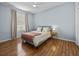 Bedroom with hardwood floors, a comfortable queen bed, and natural lighting at 821 Greenview Dr, Apollo Beach, FL 33572