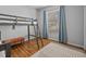 Bedroom featuring hardwood floors, bunkbeds, and natural light from a window at 821 Greenview Dr, Apollo Beach, FL 33572