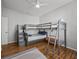 Bedroom featuring bunkbeds, hardwood floors, ceiling fan and a neutral color scheme at 821 Greenview Dr, Apollo Beach, FL 33572