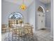 Bright dining area featuring elegant lighting, arched windows, and a stylish table with seating for six at 821 Greenview Dr, Apollo Beach, FL 33572