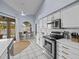 Bright kitchen featuring white cabinets, stainless appliances, and view to the pool at 821 Greenview Dr, Apollo Beach, FL 33572