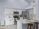 Bright, open kitchen featuring white cabinets, stainless steel appliances, and a counter with barstool seating at 821 Greenview Dr, Apollo Beach, FL 33572