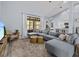 Open-concept living room featuring a comfortable sectional, large window with views, and access to the patio at 821 Greenview Dr, Apollo Beach, FL 33572