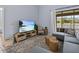 Living area with stylish decor, large flat screen TV and views through sliding glass doors to the pool at 821 Greenview Dr, Apollo Beach, FL 33572